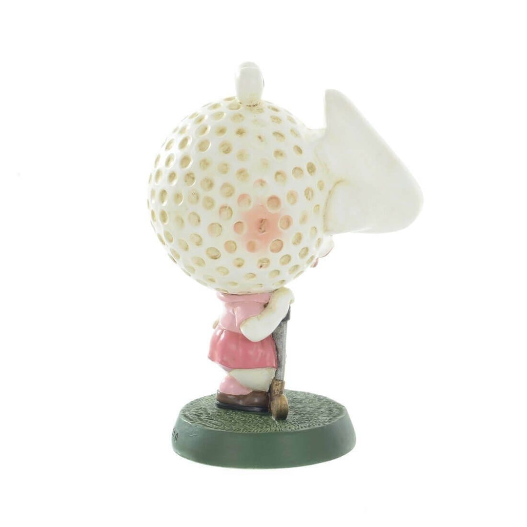 Side view of a golfer spectacles holder with golf ball head on a white background