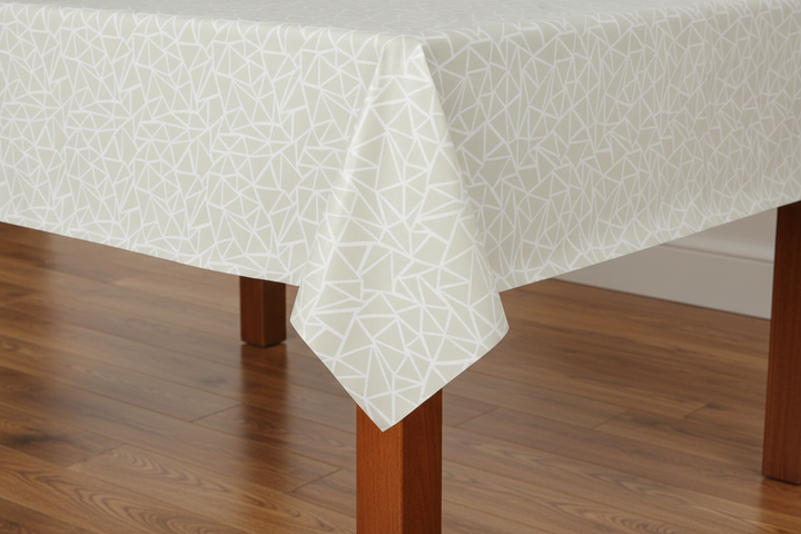 White geometric patterned tablecloth on a wooden table