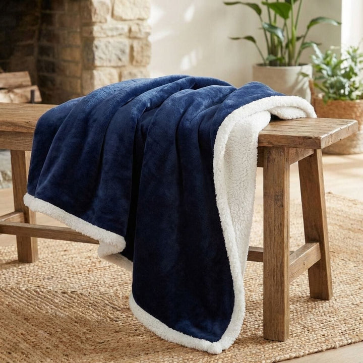 navy blue blanket with sherpa fleece reverse draped over wooden bench in living room