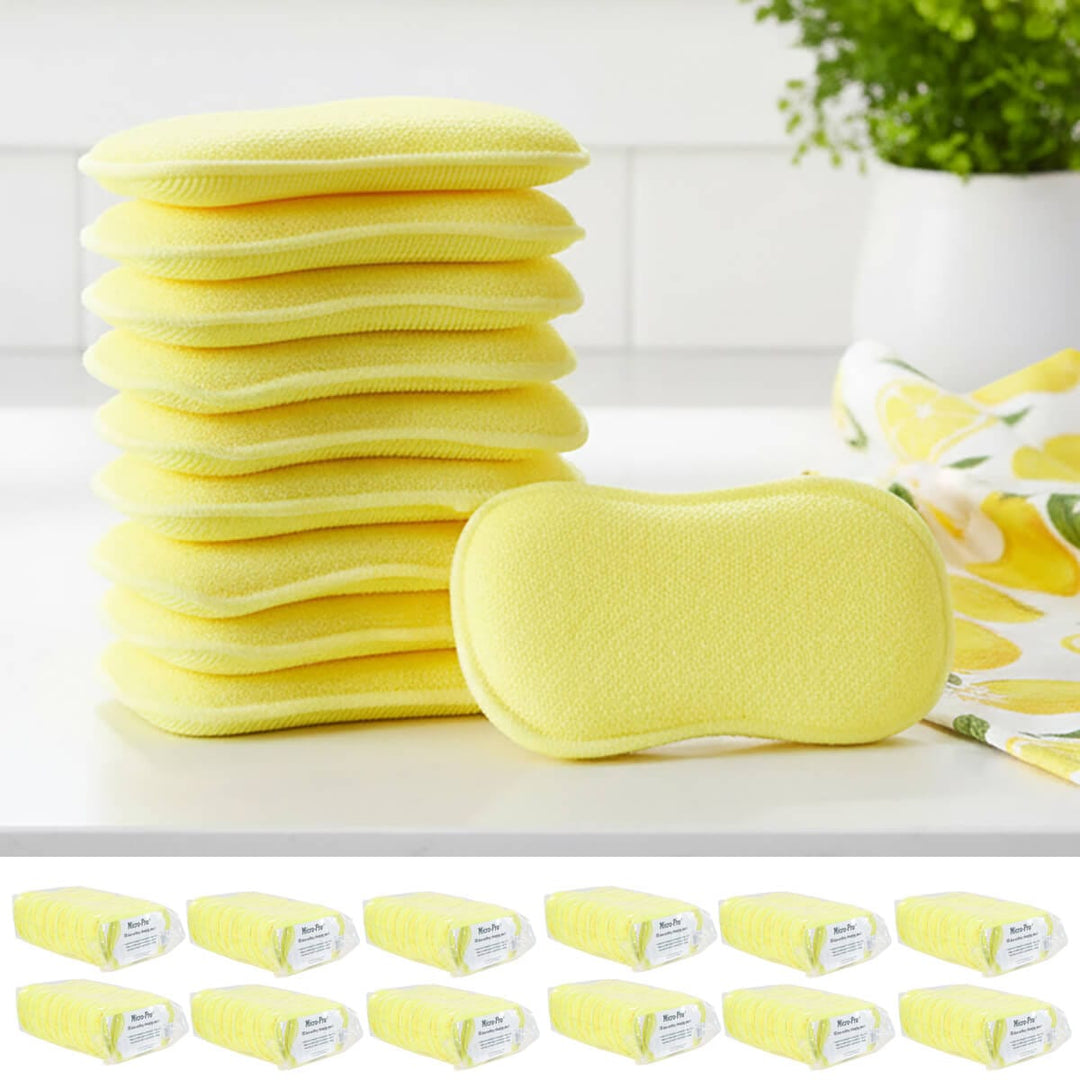 Stack of yellow cleaning pads on a white surface with a plant in the background.