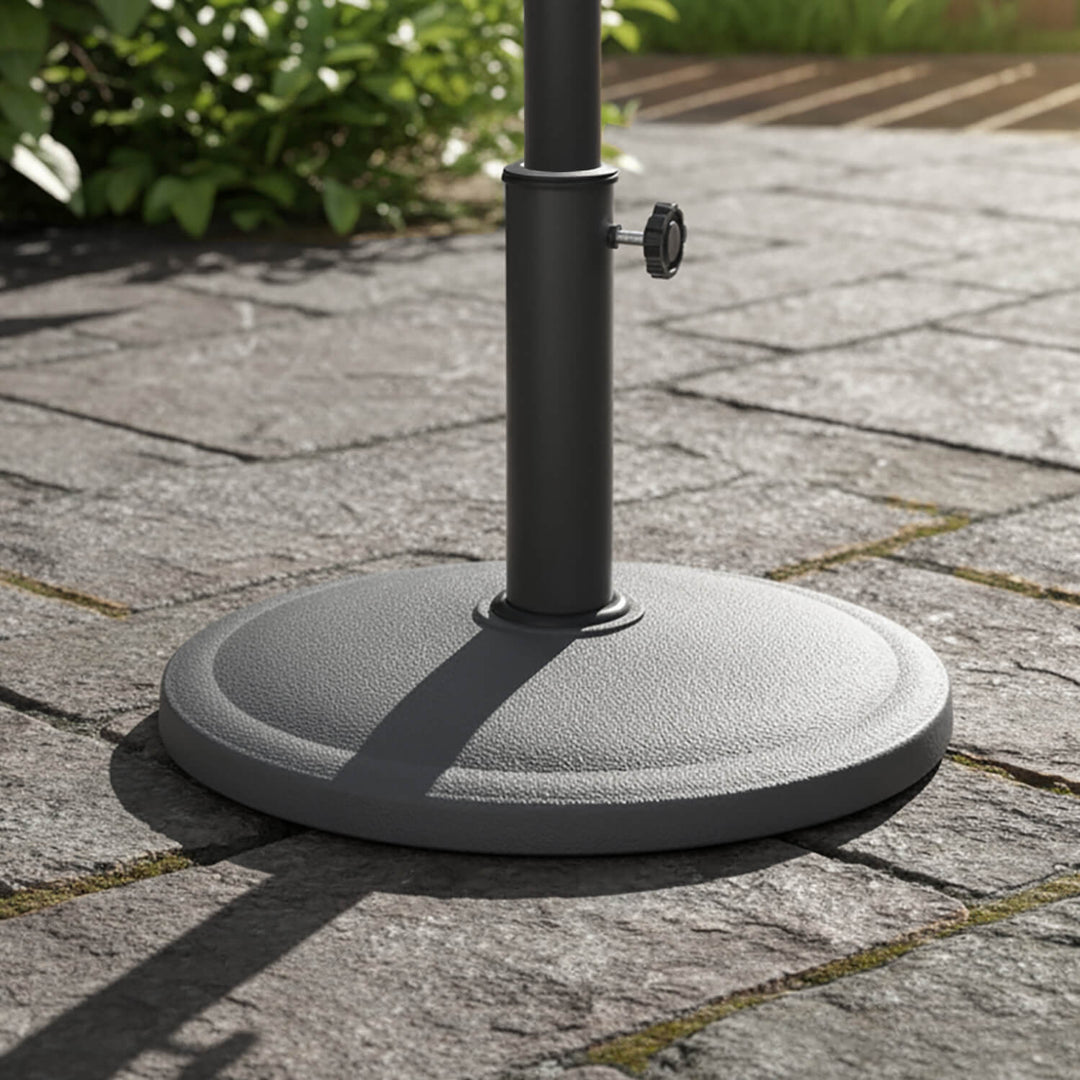Grey parasol base on a stone patio