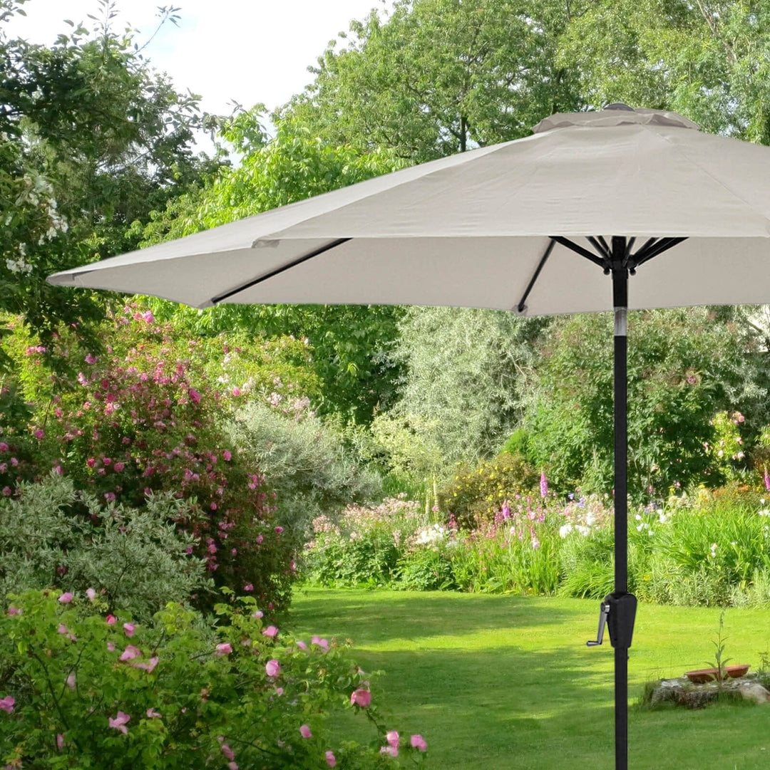 Silver canopy sun parasol in a garden setting with greenery and flowers.