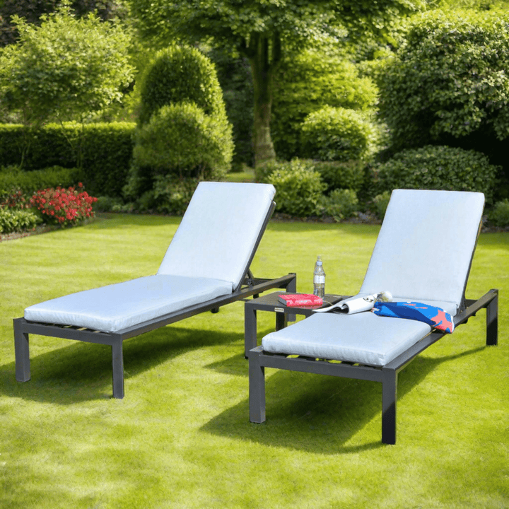 Grey Sun Loungers in a Green Lush Garden Setting