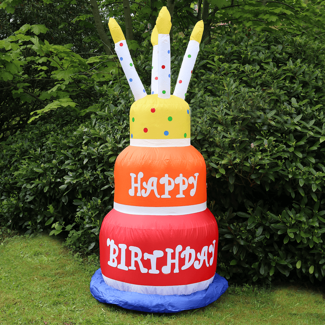 happy birthday inflatable in garden space in front of green trees and foliage