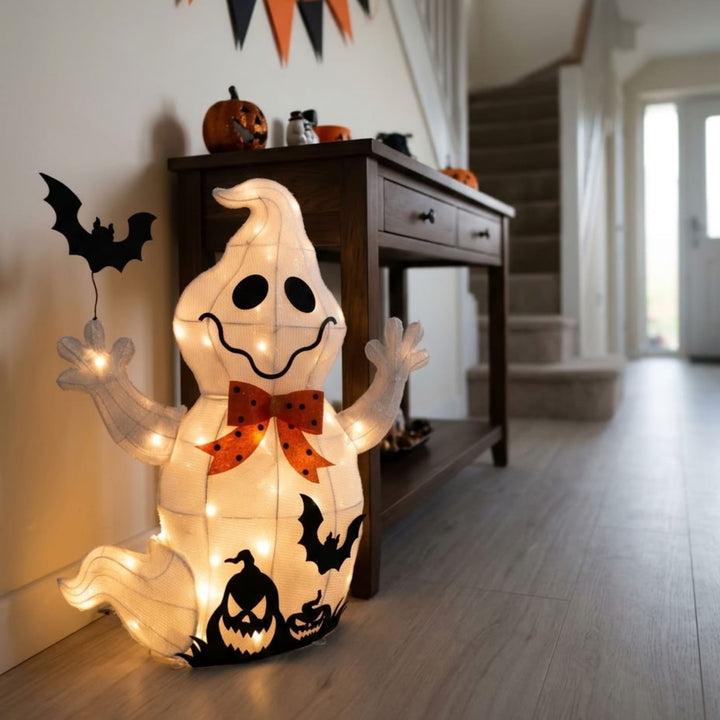 A glowing Halloween ghost floor decoration with integrated string lights, black bat cutouts, and jack-o&