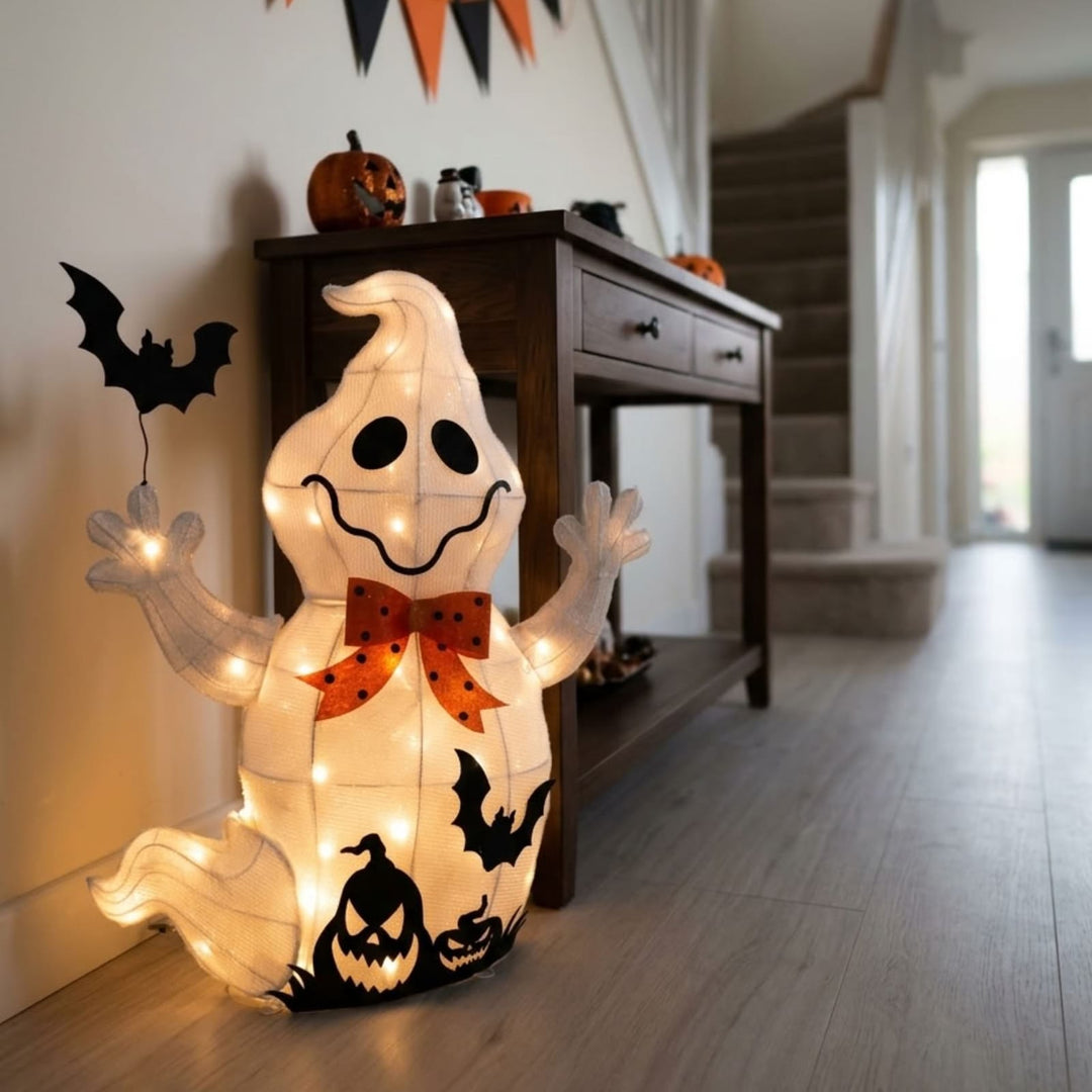 A glowing Halloween ghost floor decoration with integrated string lights, black bat cutouts, and jack-o&