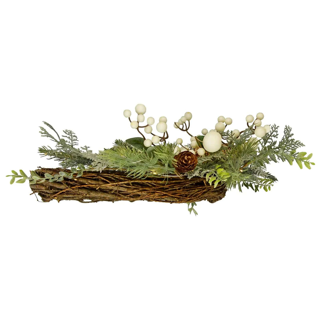 Side view profile of a Christmas wreath with foliage and snowberries on a rattan weave base