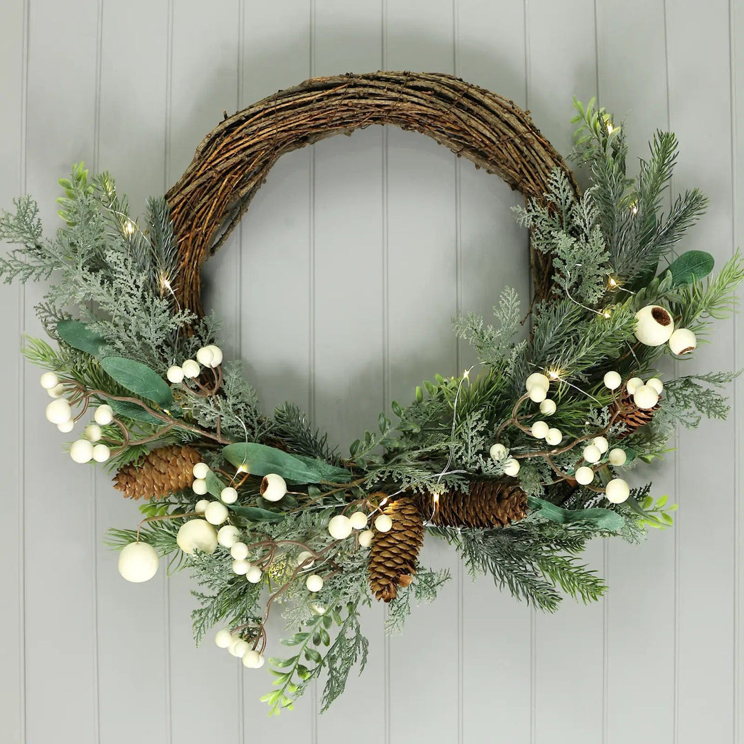 Light up Christmas wreath with pine cones, white berries and woven twig base 