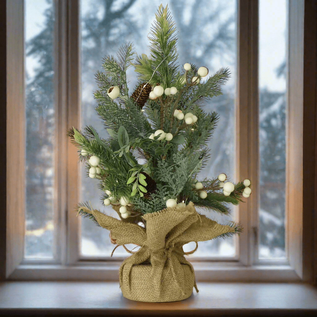 Christmas tree with pine cones, white berries and brown fabric base