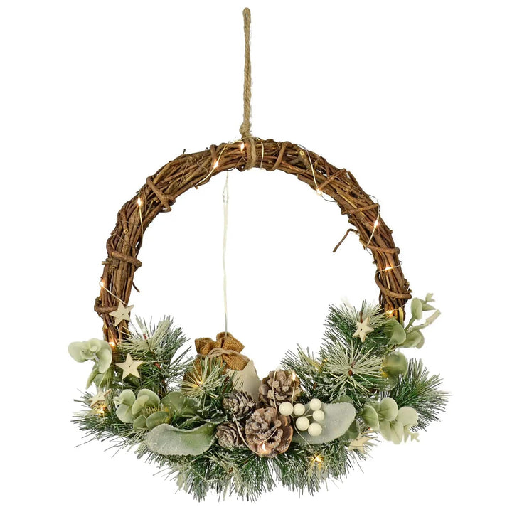 Christmas half wreath with frosted pine cones, branches, white berries, warm white lights and a woven rattan base with hanging loop