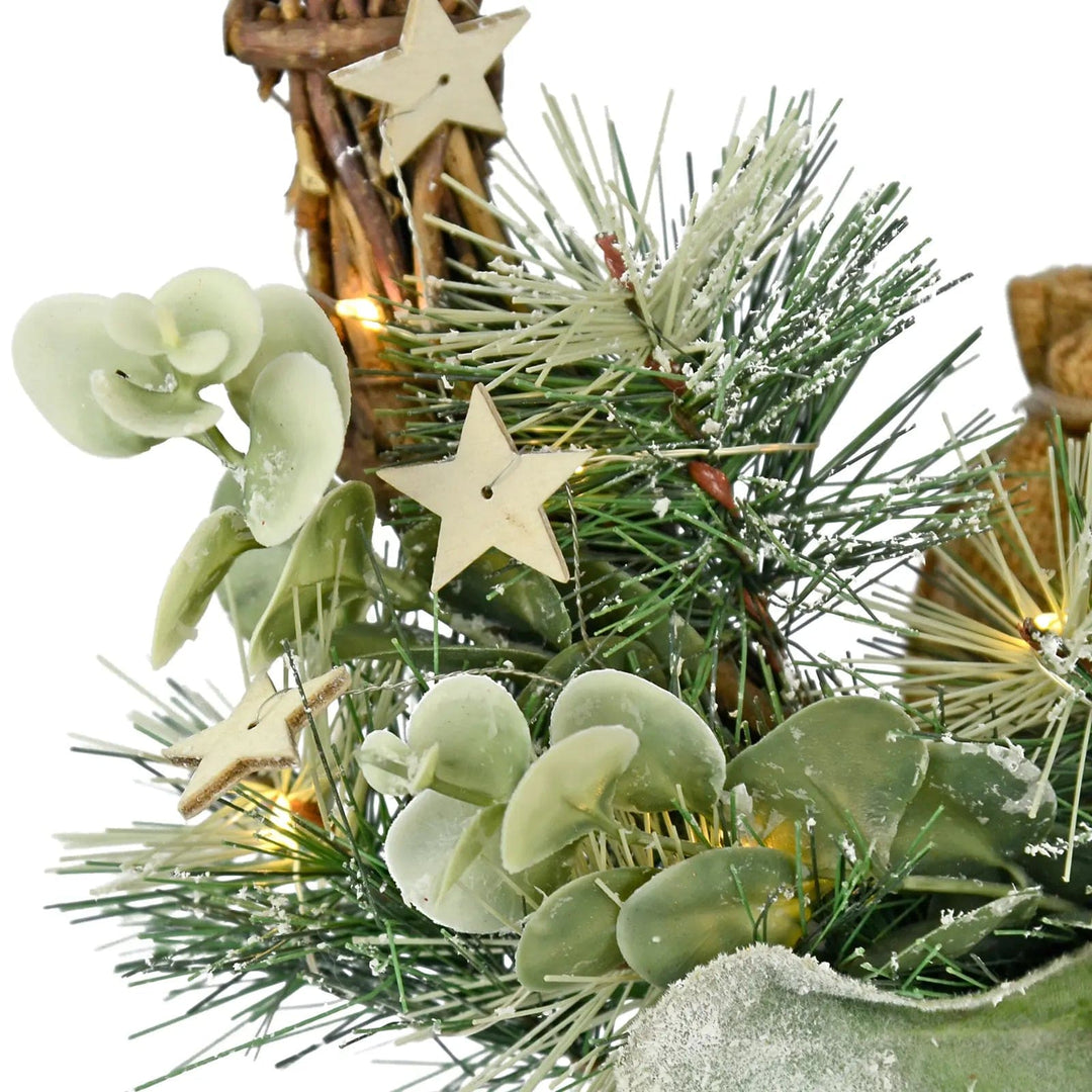 pine branches, wooden stars, eucalyptus leaves and fairy lights