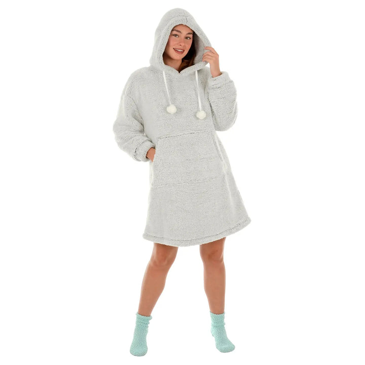 female model wearing a hooded fleece in light gray with pom poms