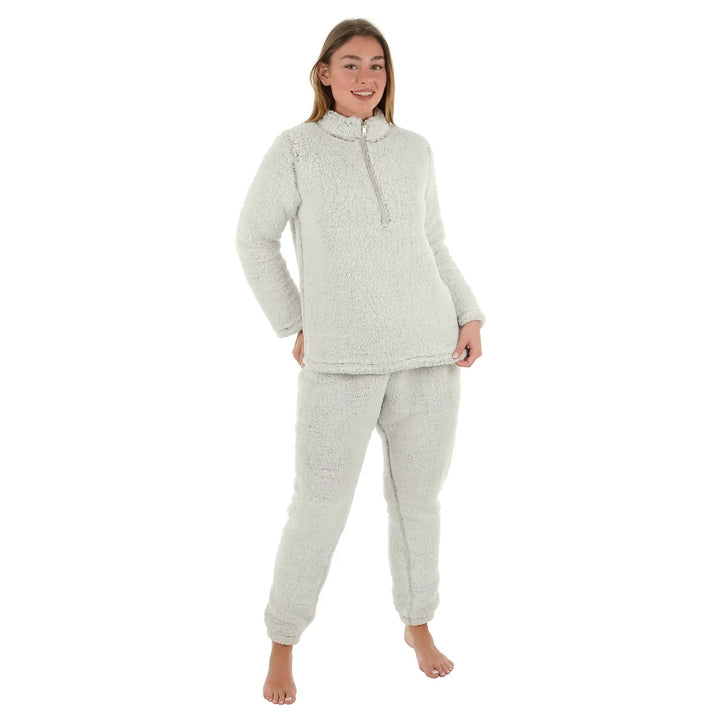 Female model wearing light grey fleece pyjamas