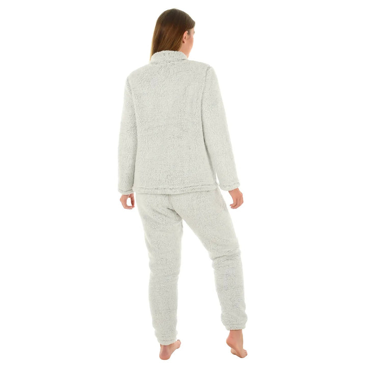 Back view of a woman wearing a light grey sherpa fleece pyjama set