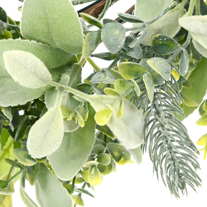 Close up of spruce twig and eucalyptus leaves on a Christmas wreath to decorate your front door