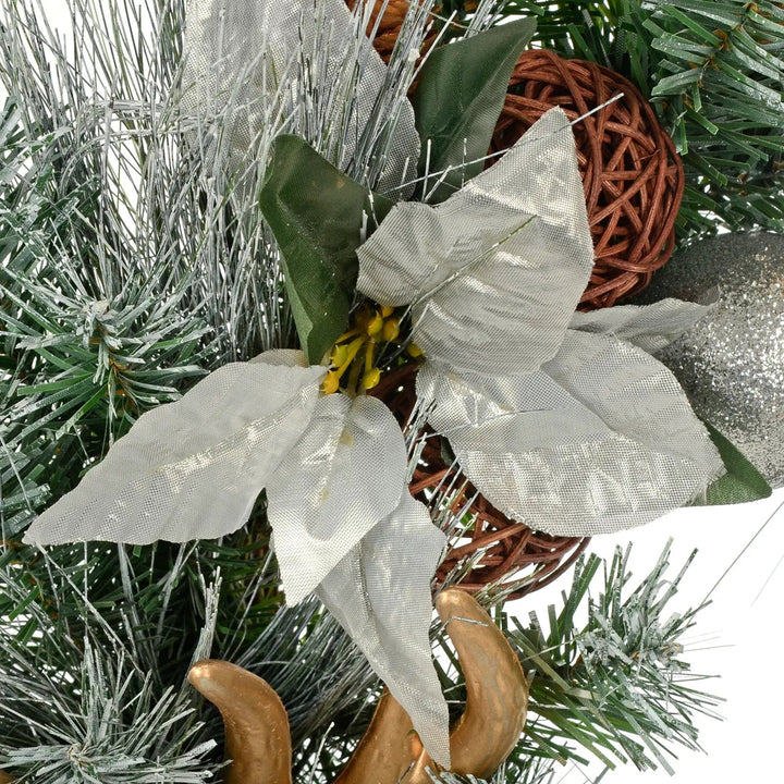 Silver poinsettia flower on a frosted Christmas wreath