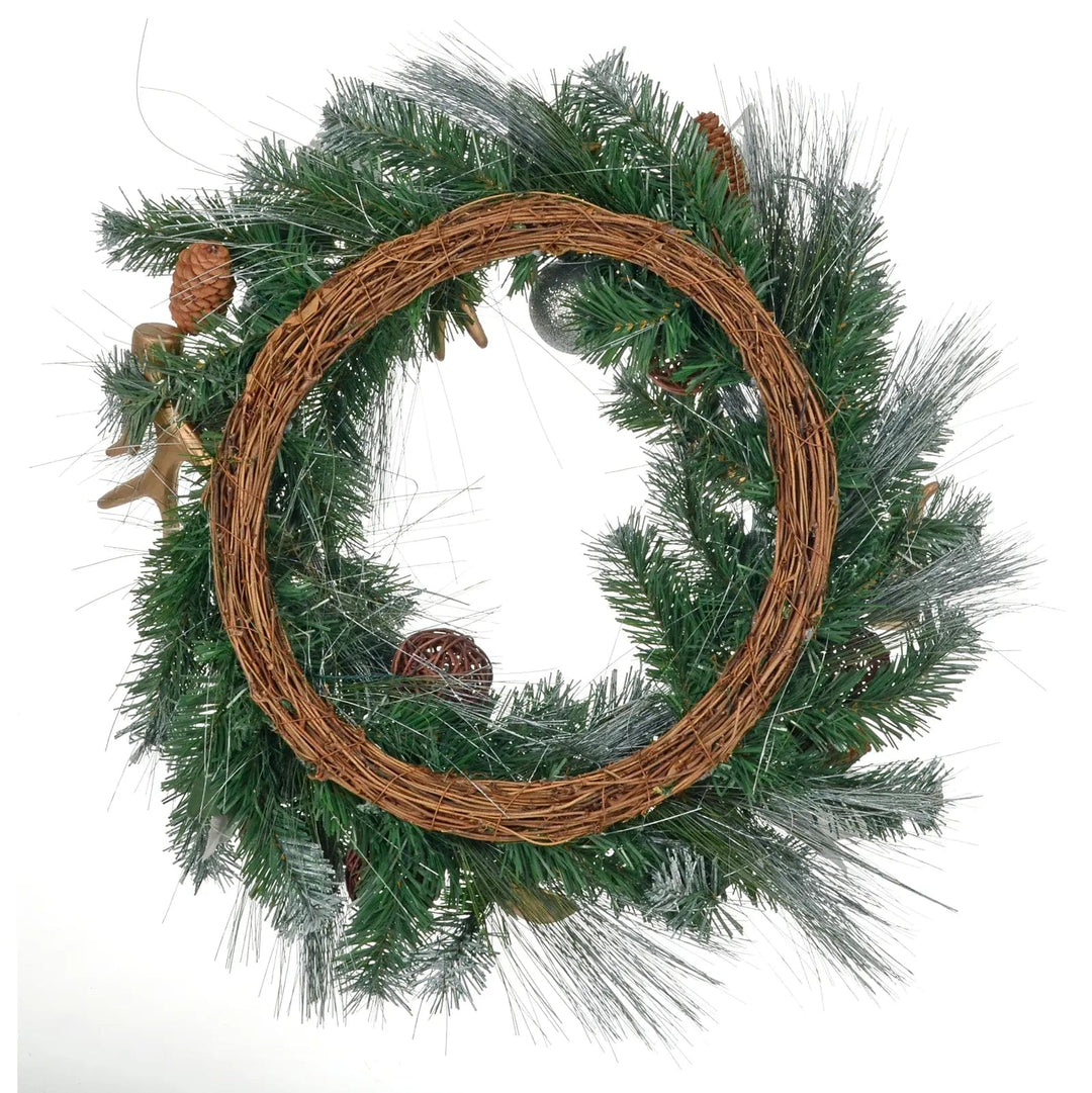 Back view of a Christmas wreath with frosted green pine foliage and a brown woven rattan base