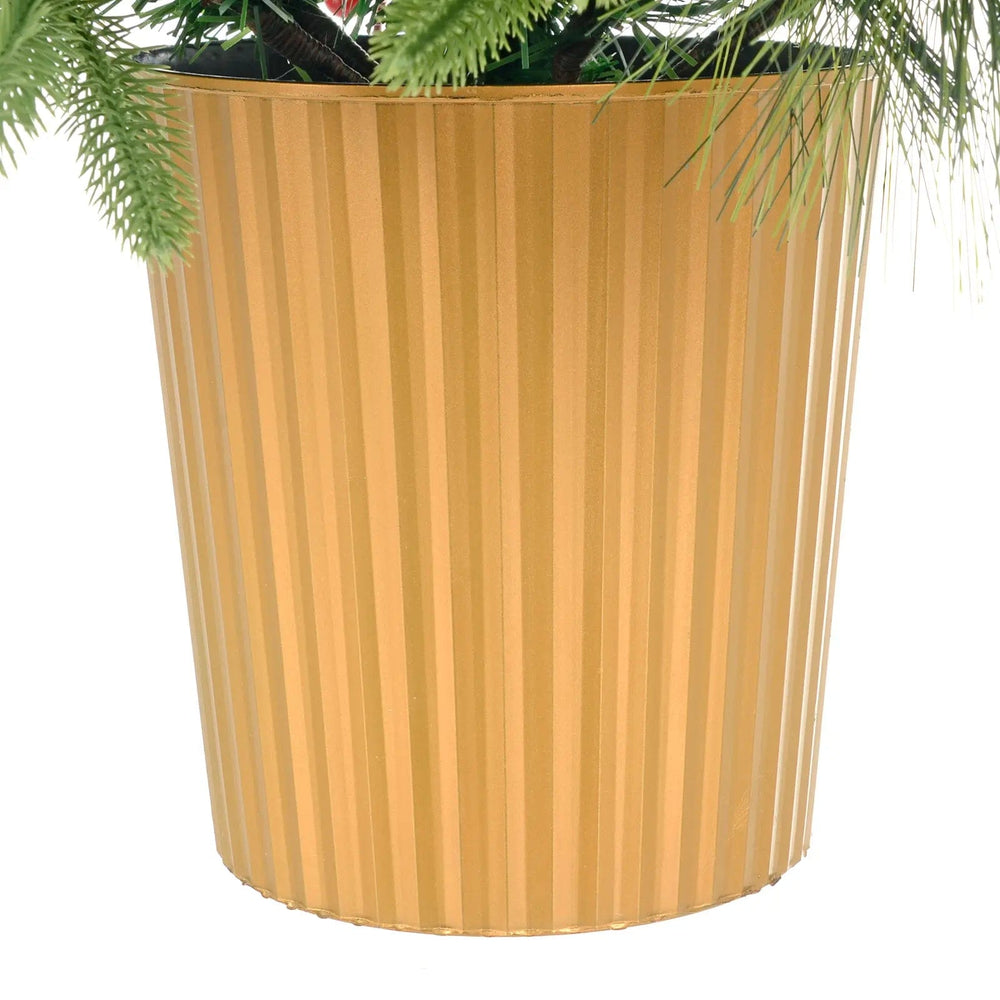 Close up of a gold fluted base pot for a green pine Christmas tree