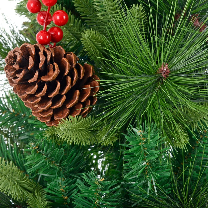 Green larch and fir tree branches, pine cone and red berries on a Christmas tree