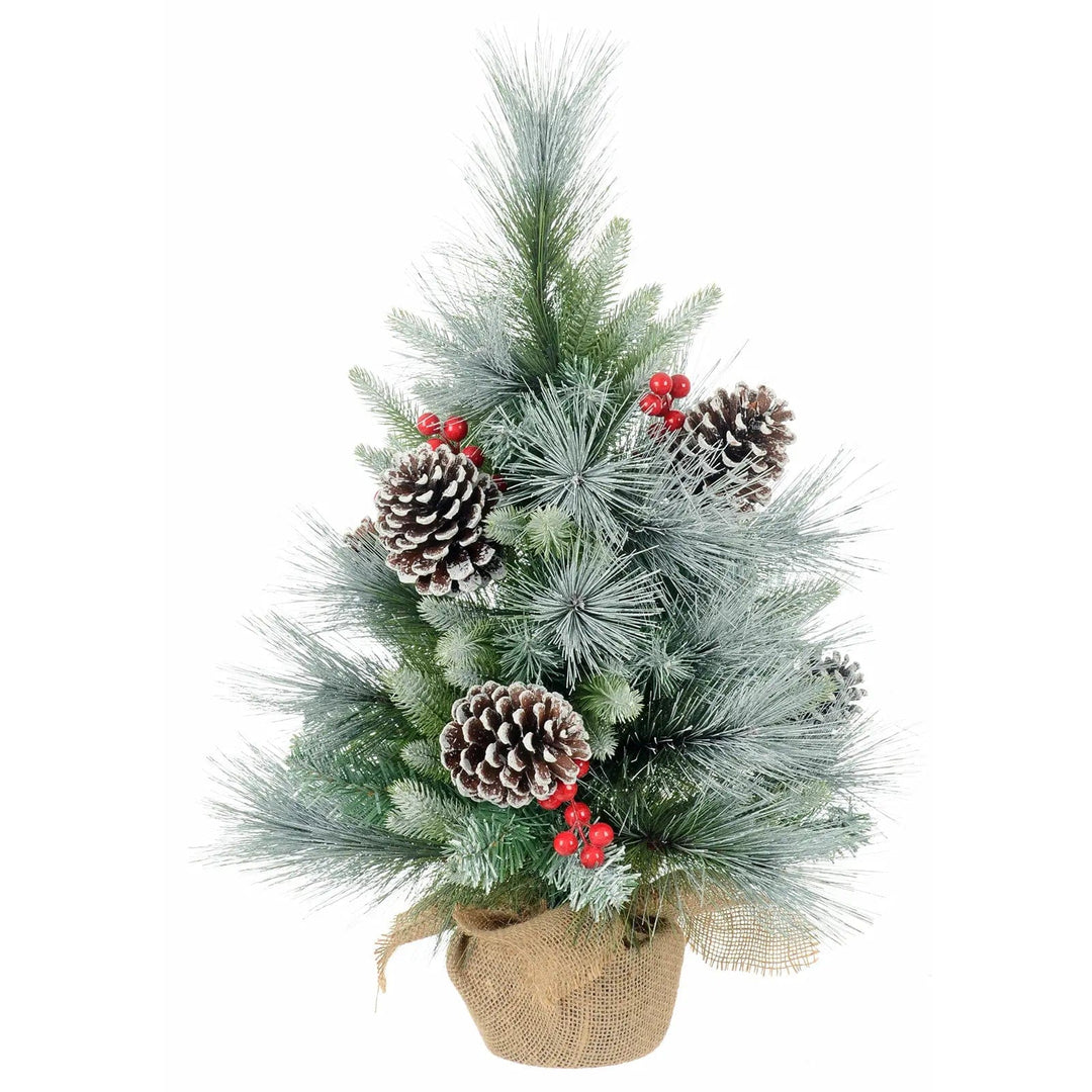 Small Christmas tree with frost covered branches, pine cones, red berries and a jute fabric covered base