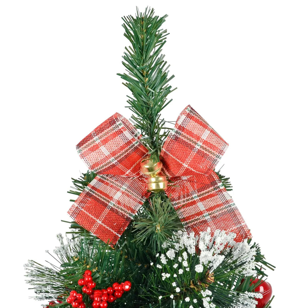 Close up of a red tartan bow with gold sleigh bells on an artificial Christmas tree