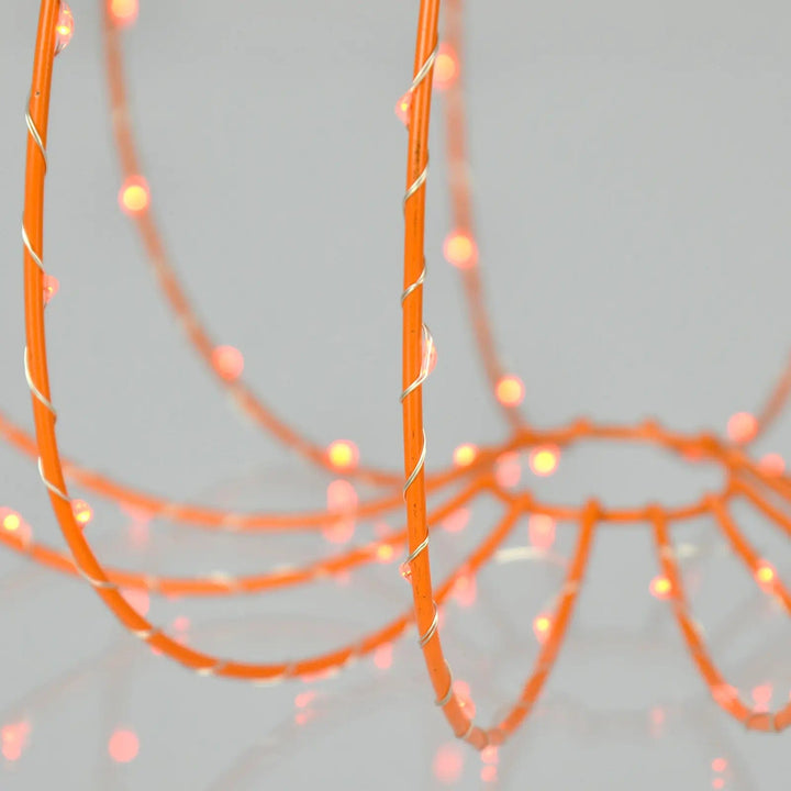 Close up of orange LED lights on the orange frame on a Halloween pumpkin decoration