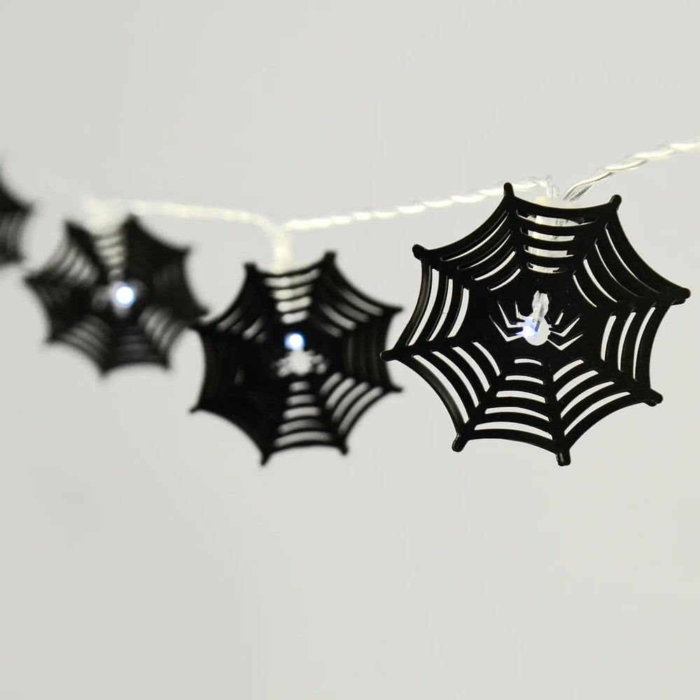 Black spider web string lights with cool white LEDs on a clear wire