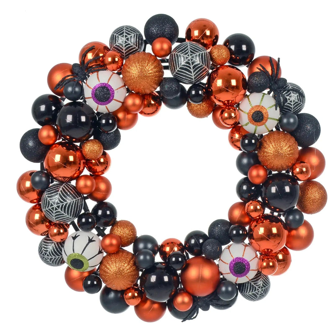 Halloween door wreath with black and orange baubles, eyeballs, spiders and pumpkin pattern baubles