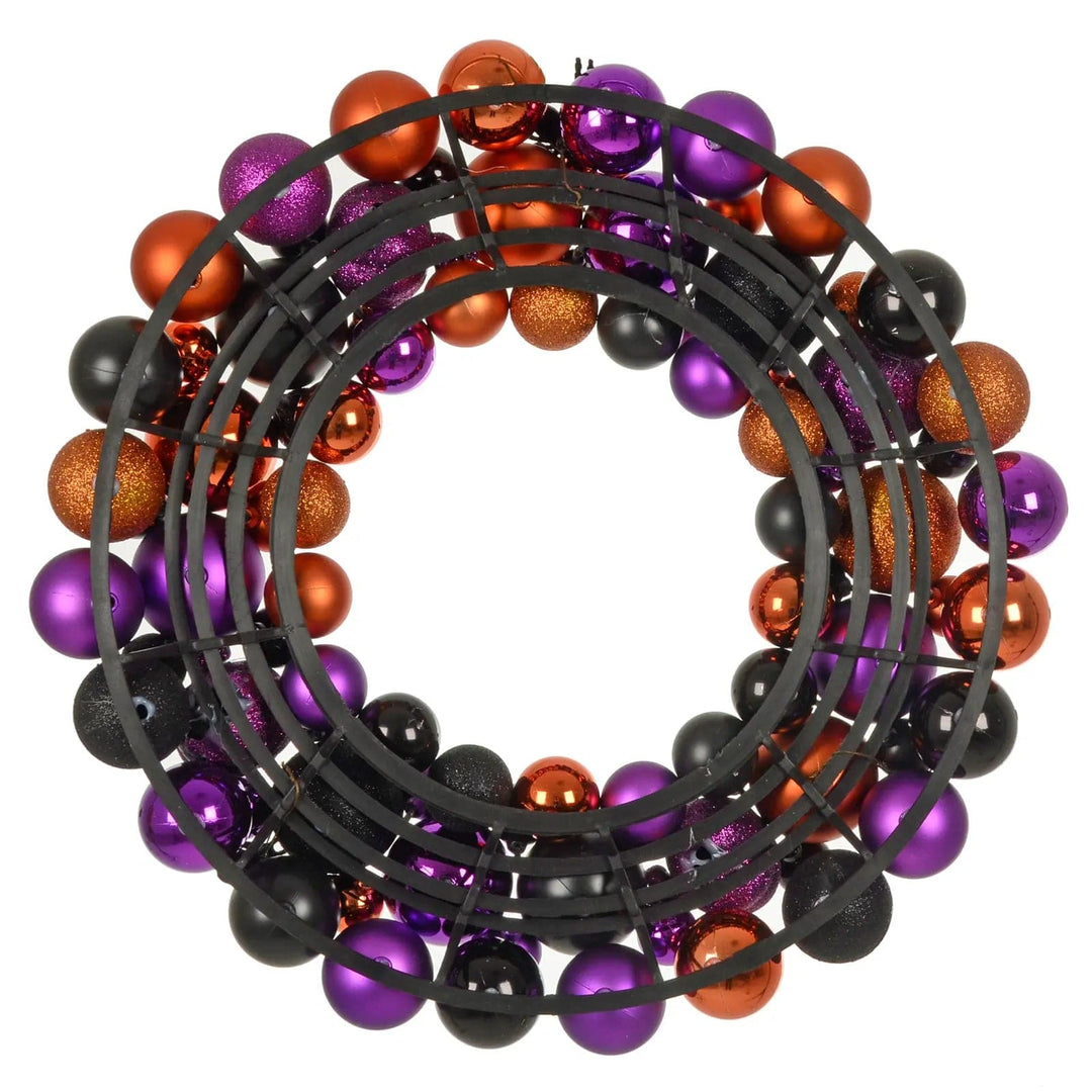 Back view of a Halloween wreath with black, purple and orange baubles