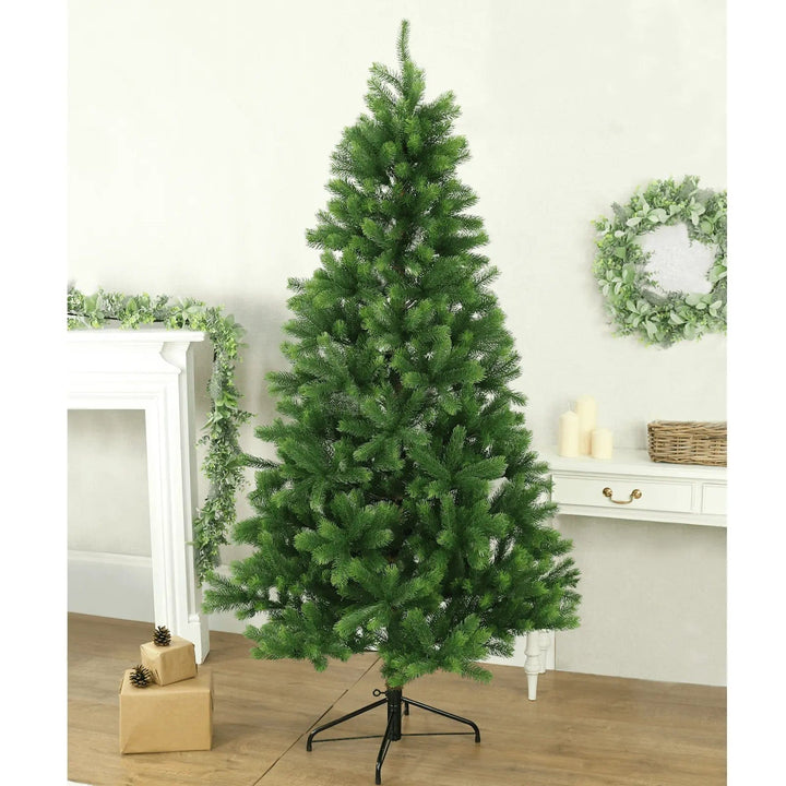 Green pine artificial Christmas tree in a living roomwith garland and wreath decorations