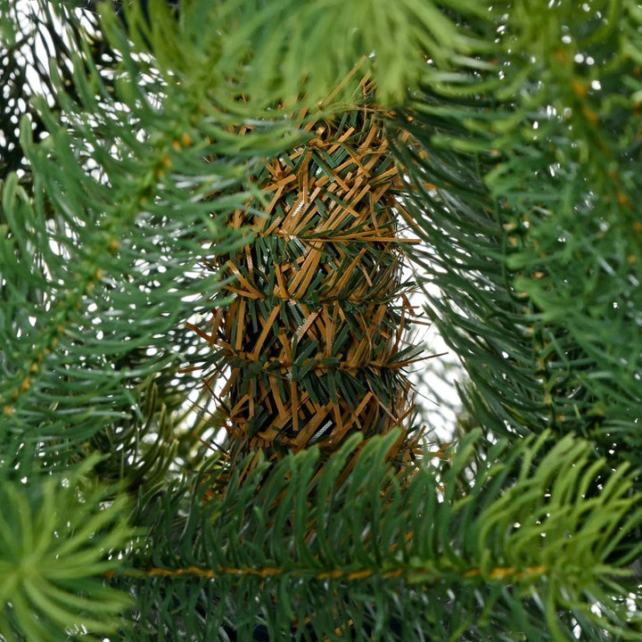 Close up of branches and trunk of artificial green pine Christmas tree