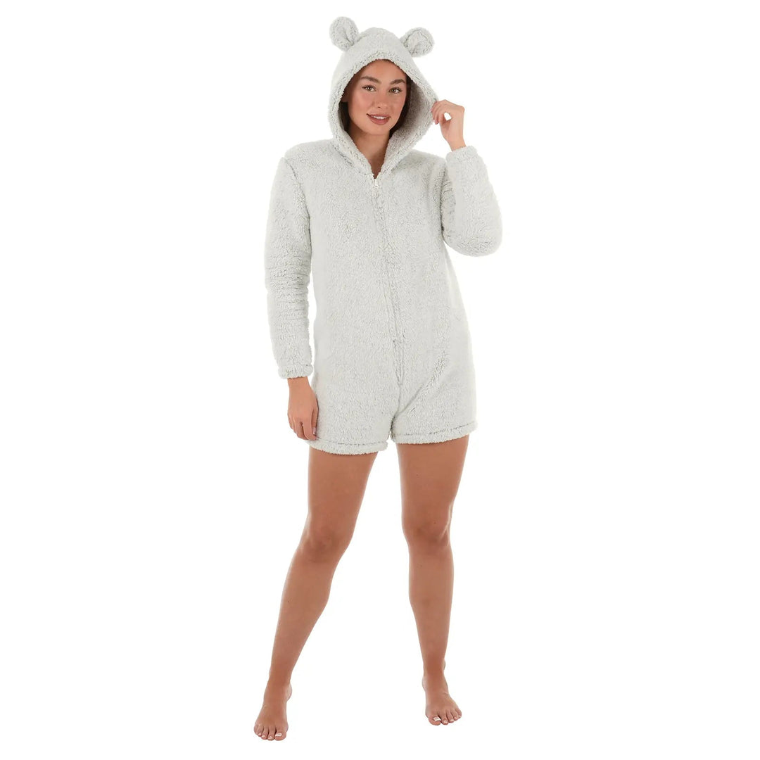 Woman wearing a light grey sherpa fleece romper suit with hood and teddy ears