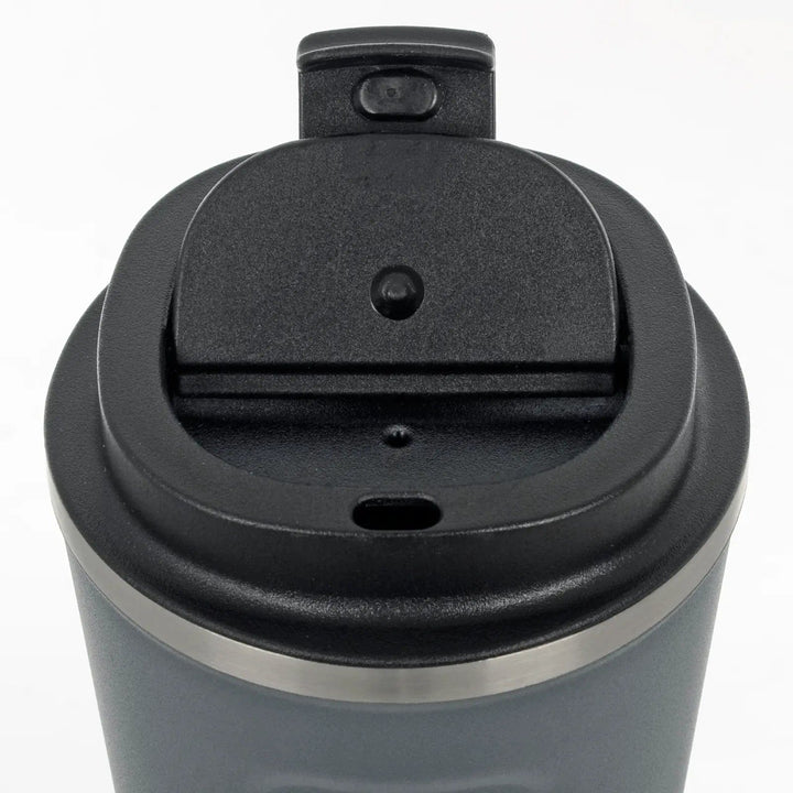 Close up of lid on insulated coffee mug showing mouthpiece and air vent