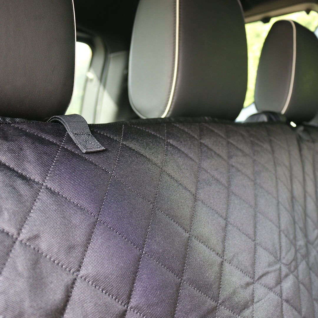 detail shot of black heavy duty material on back car seat against headrests