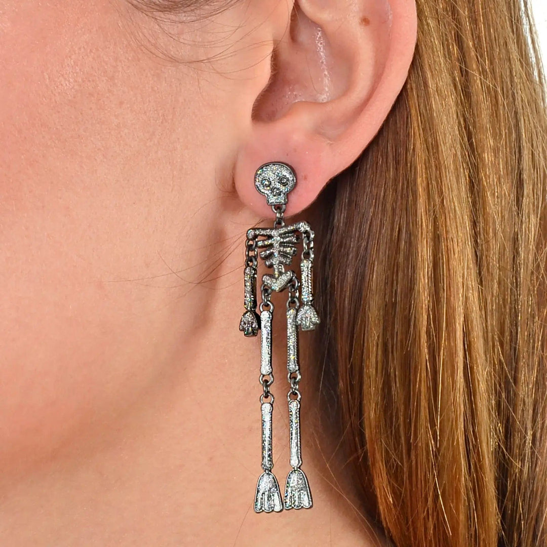 Long skeleton drop earrings with silver glitter and jointed limbs to move at Halloween parties