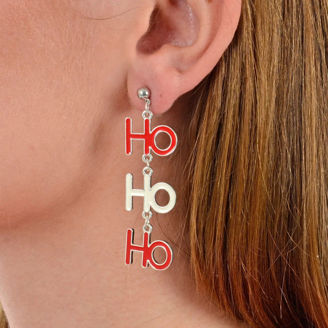 Model wearing Ho Ho Ho drop earrings in red and white for Christmas parties