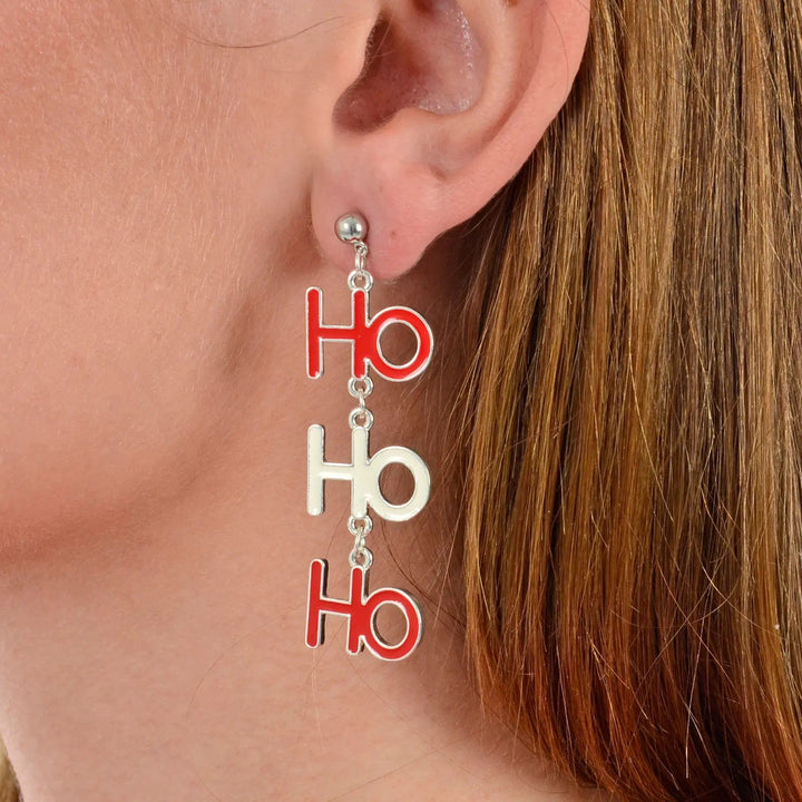 Model wearing Ho Ho Ho drop earrings in red and white for Christmas parties