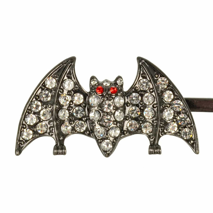 Close up of bat decoration of a Halloween hair slide, with diamante and red jewel eyes