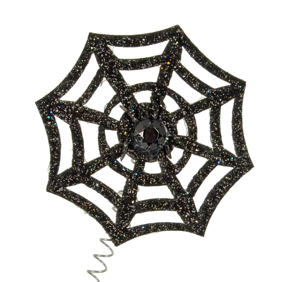 Close up of a black glitter spiders web with black gemstone in the centre