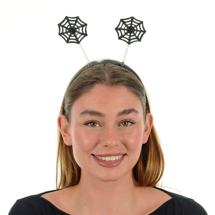 Young lady wearing a set of black spider web head boppers for Halloween fancy dress costumes