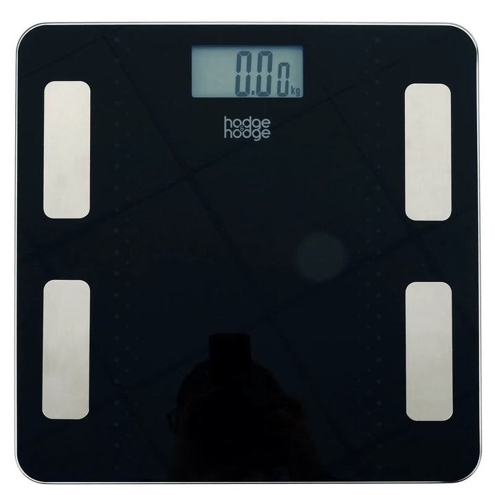 Top view of hodge and hodge black bathroom scales with blue backlit LCD display, 4 silver sensors on a glass platform