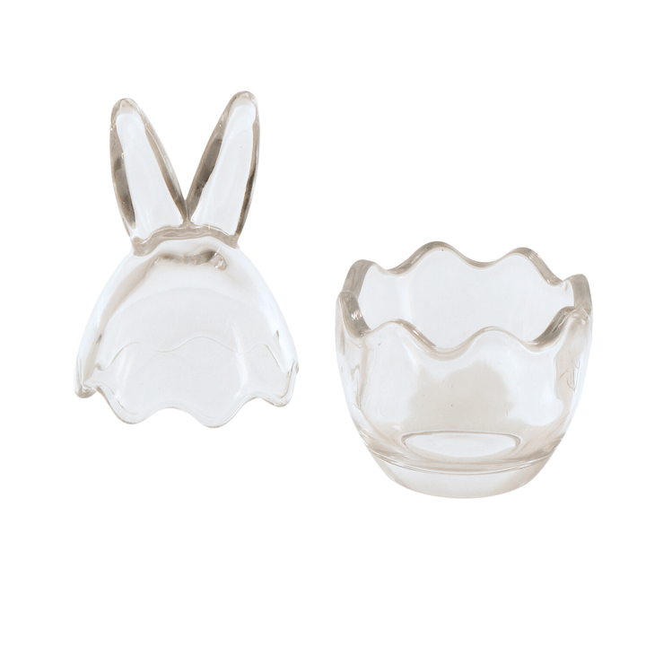 small glass bunny ear storage jar with lid removed and sitting beside the storage jar