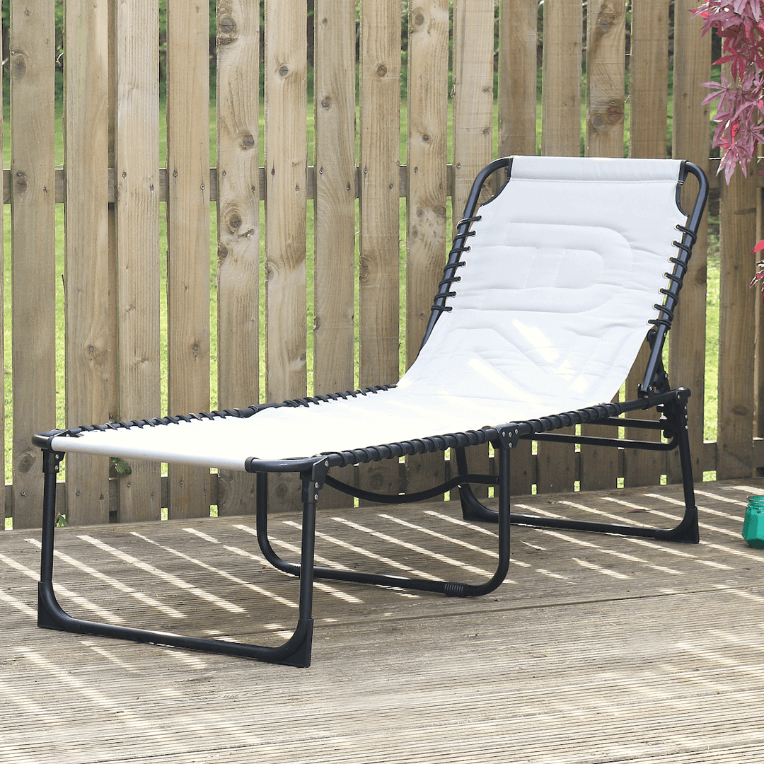 silver grey sun lounger on patio space beside red coloured maple tree