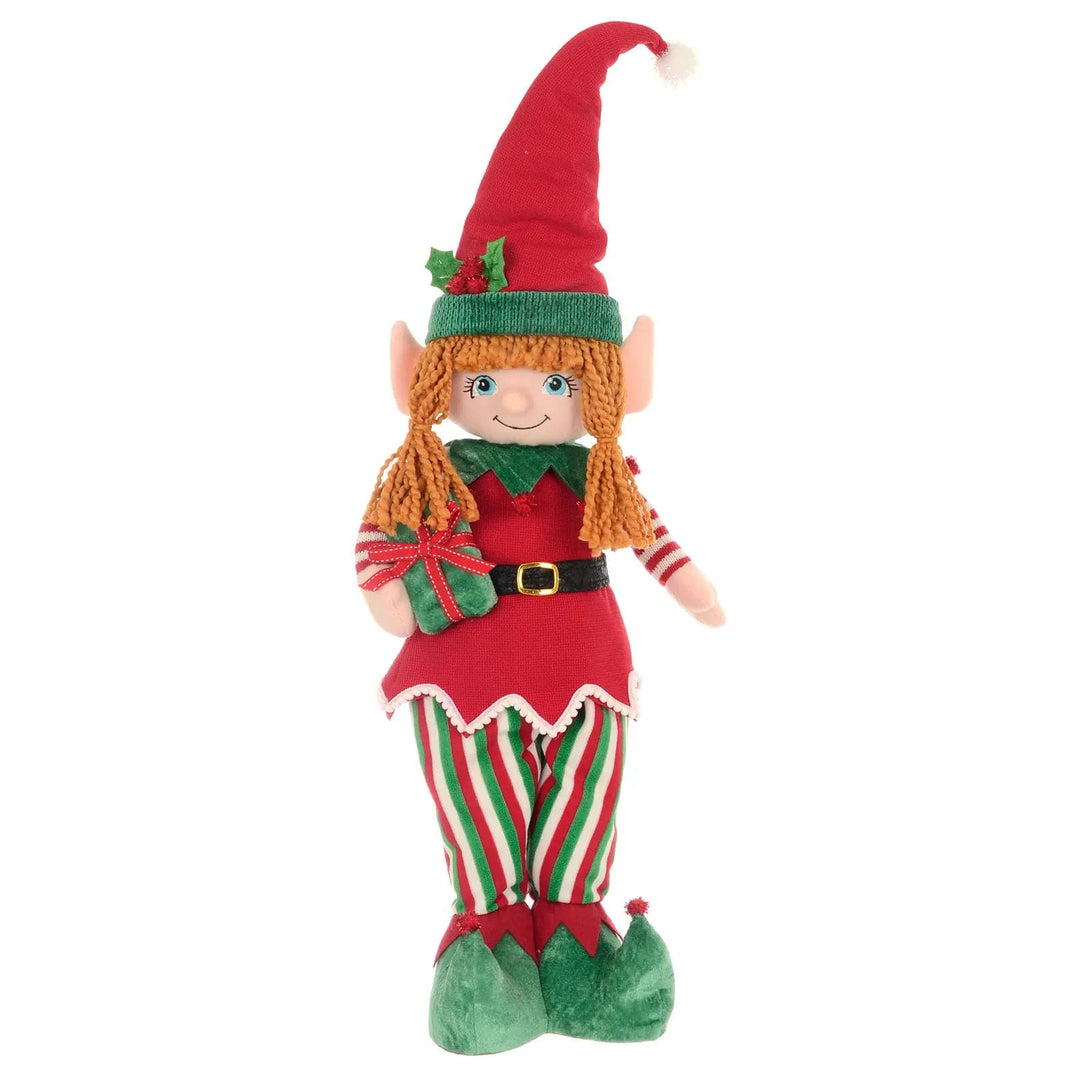 Christmas Girl elf Christmas figure standing with green striped trousers holding a gift