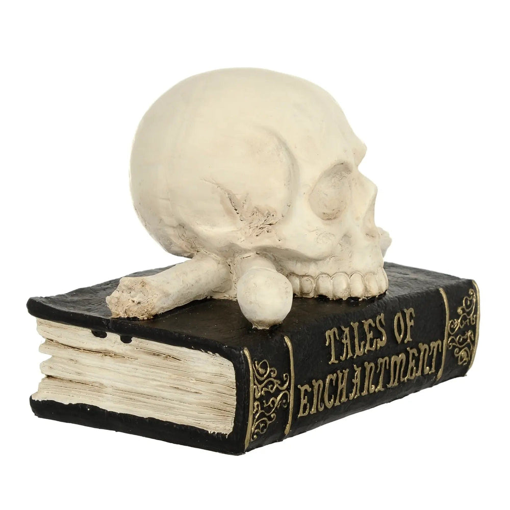 side view of skull decoration on book with tales of enchantment text in gold finish