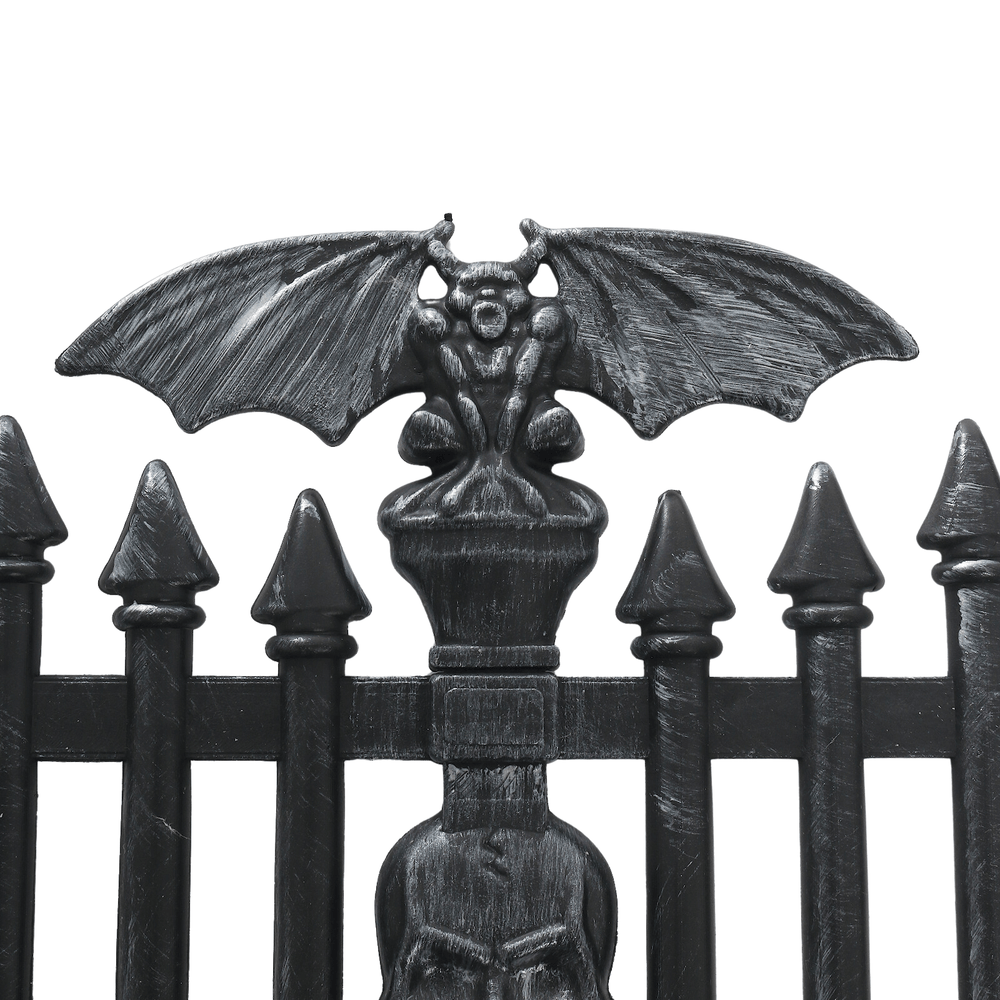 close up view of goblin with wings on top of garden fence piece