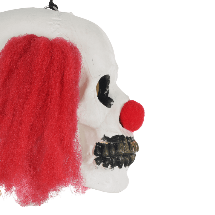 side view of scary clown face with red pom pom nose