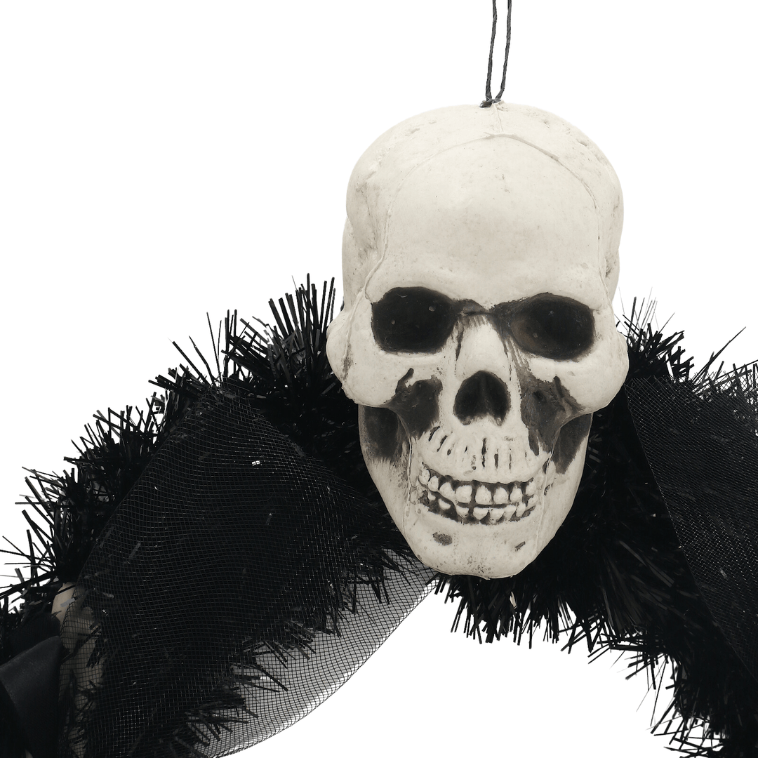 close up of skull head on halloween wreath with hanging loop
