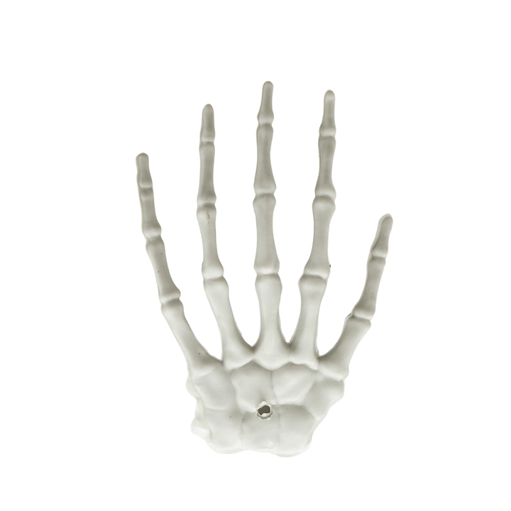 front view of single skeleton hand decoration with hole to feed string through for hanging