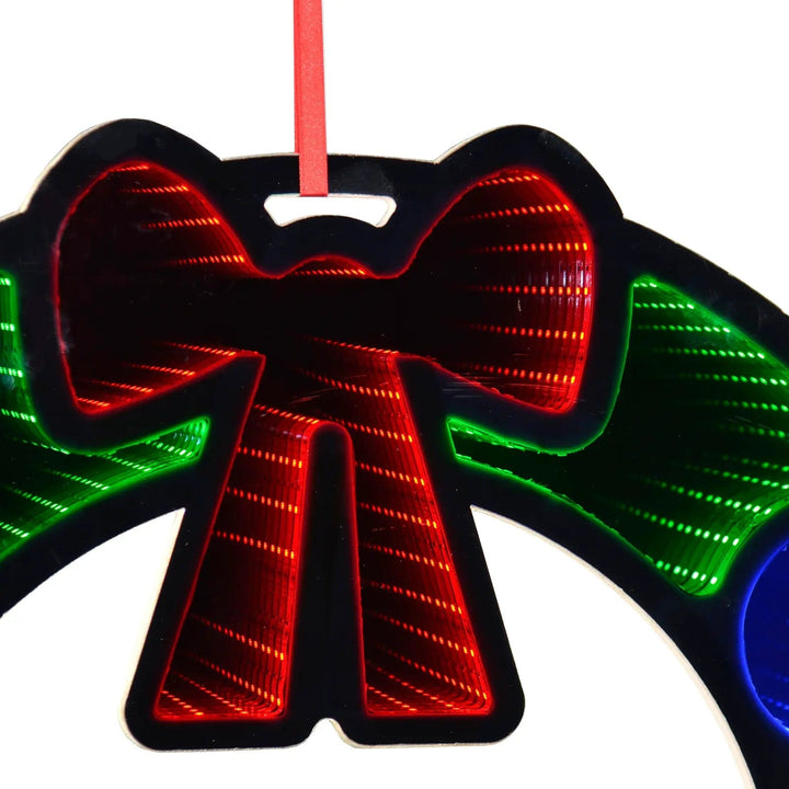 Close up of LED lights in the red bow of a Christmas wreath infinite mirror decoration